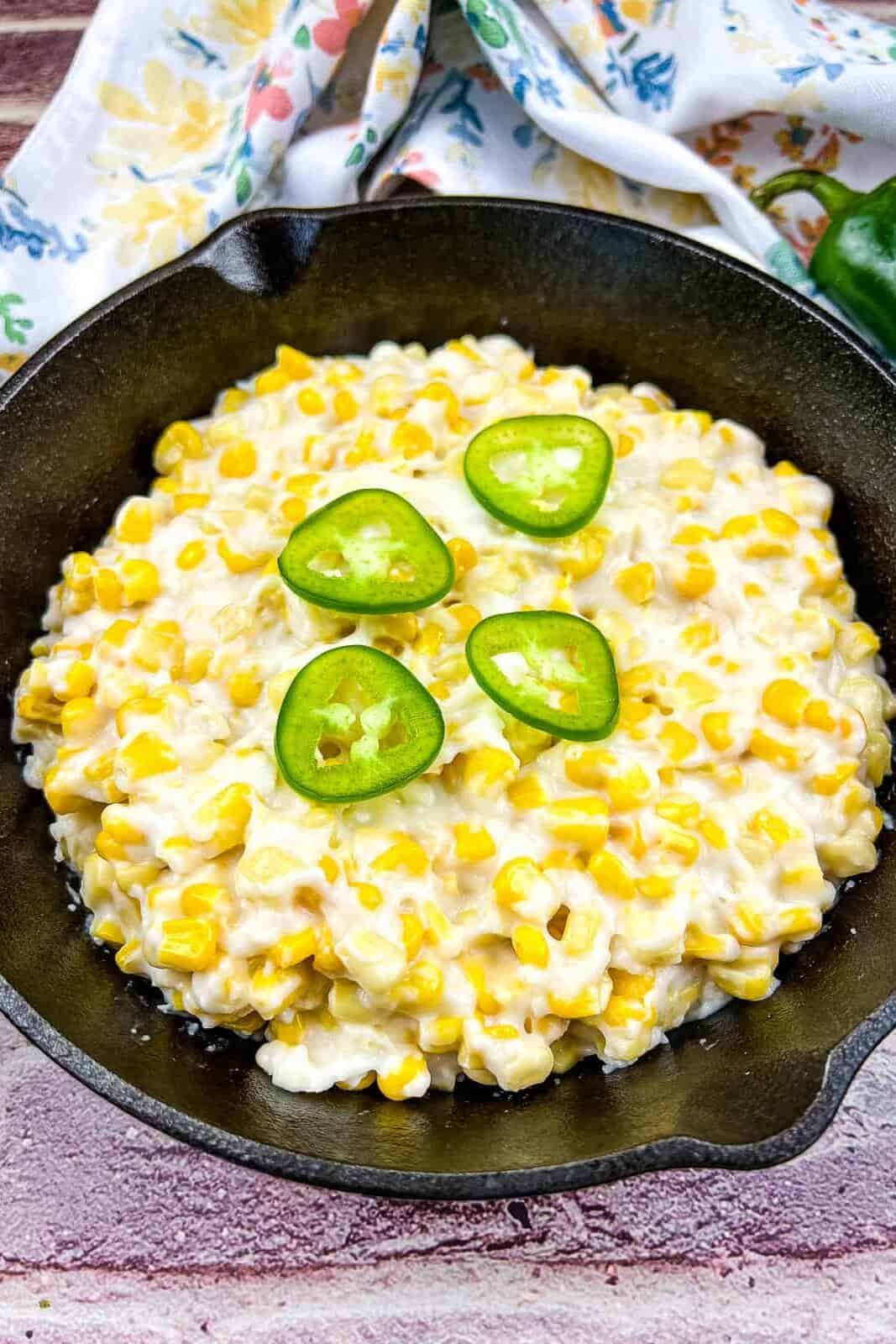 Smoked creamed corn in a black skillet.