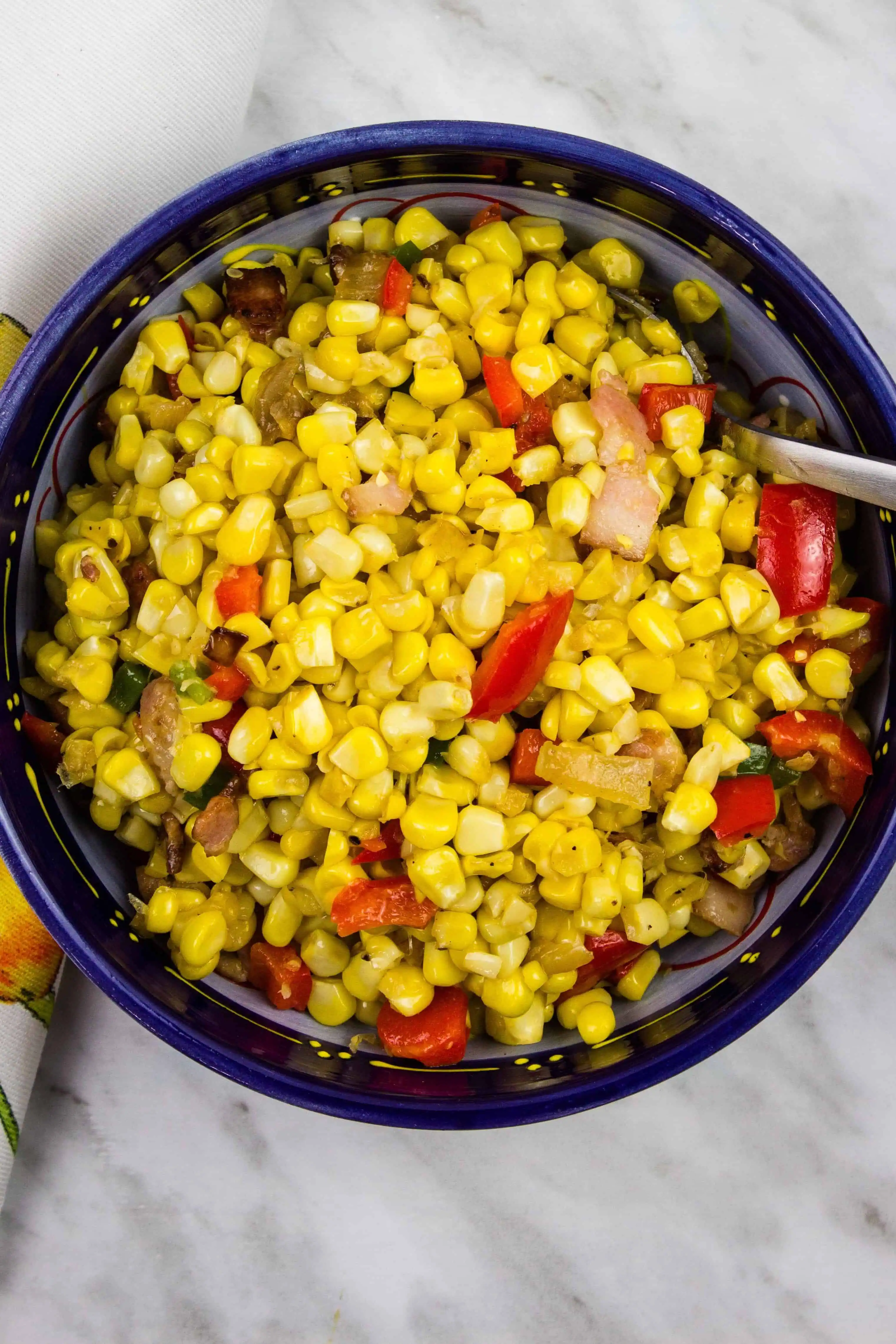 texas corn succotash in a dark blue serving bowl