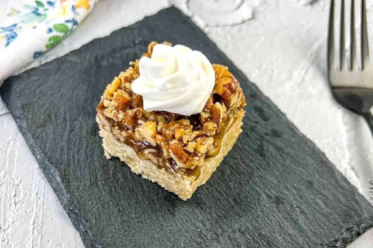 Maple Pecan Pie Bars on a black plate