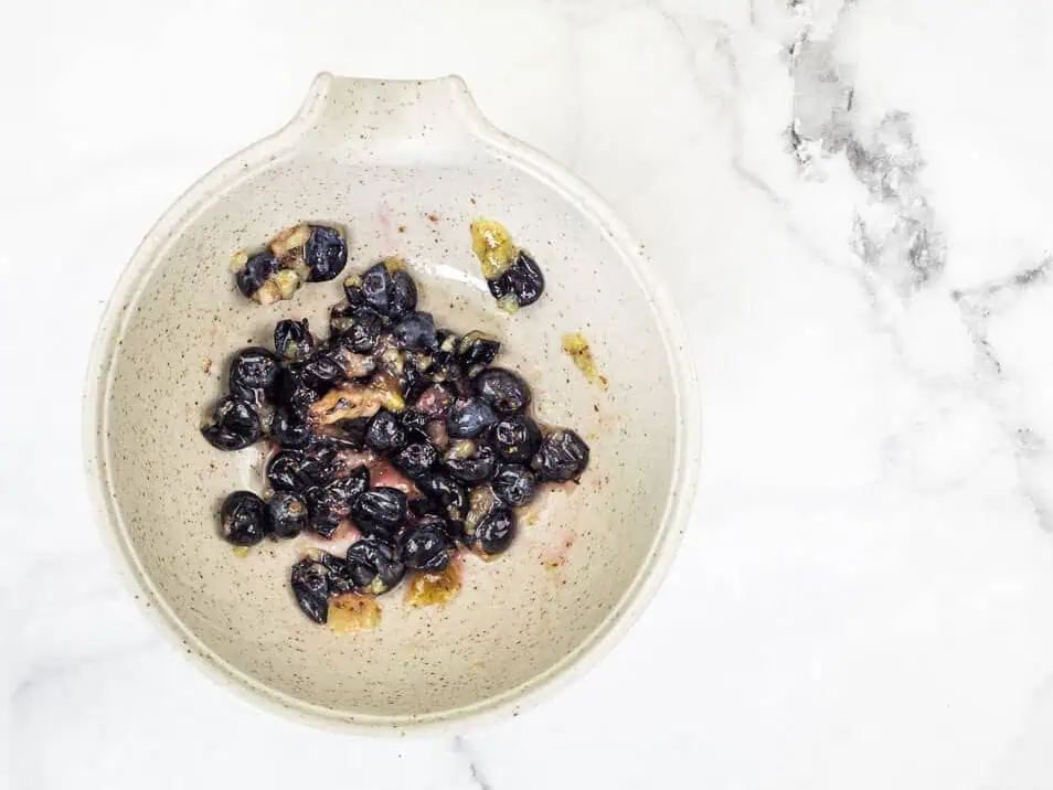 Smashed blueberries in a bowl.