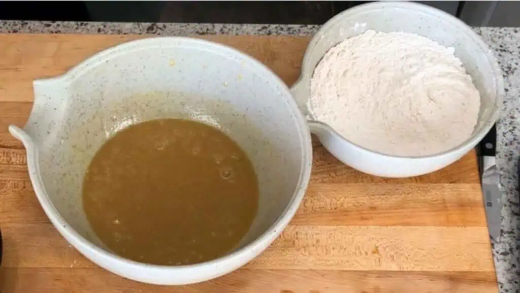 Two bowls of dry and wet ingredients for the Apple Cider Mini Donuts.