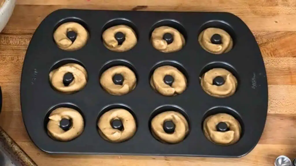 Pipe it into the donut cavities, filling each one about halfway.